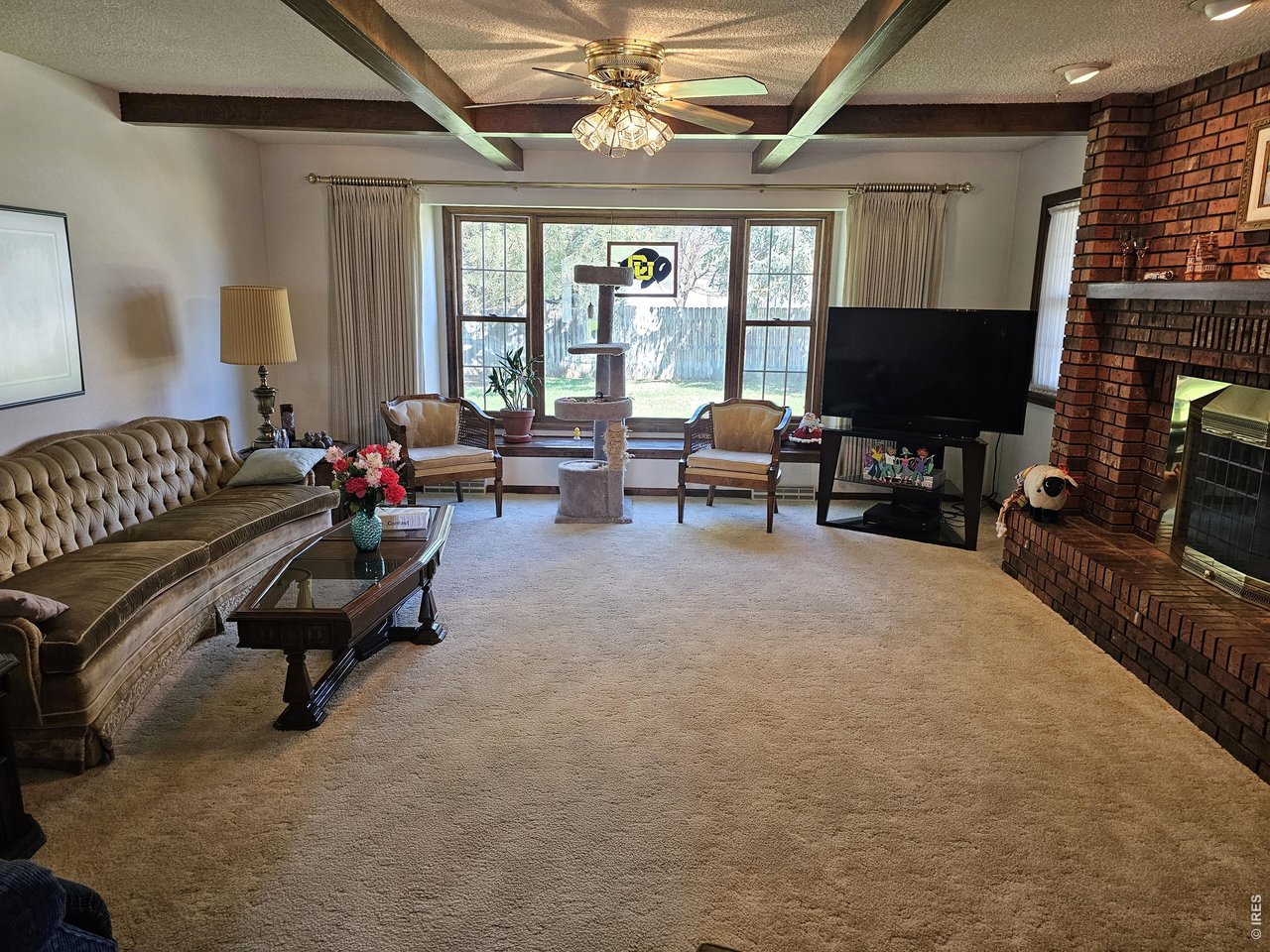 1010 Fairhurst Street Sterling, CO 80751 - Photo 4 of 36 a living room with furniture a fireplace and a flat screen tv