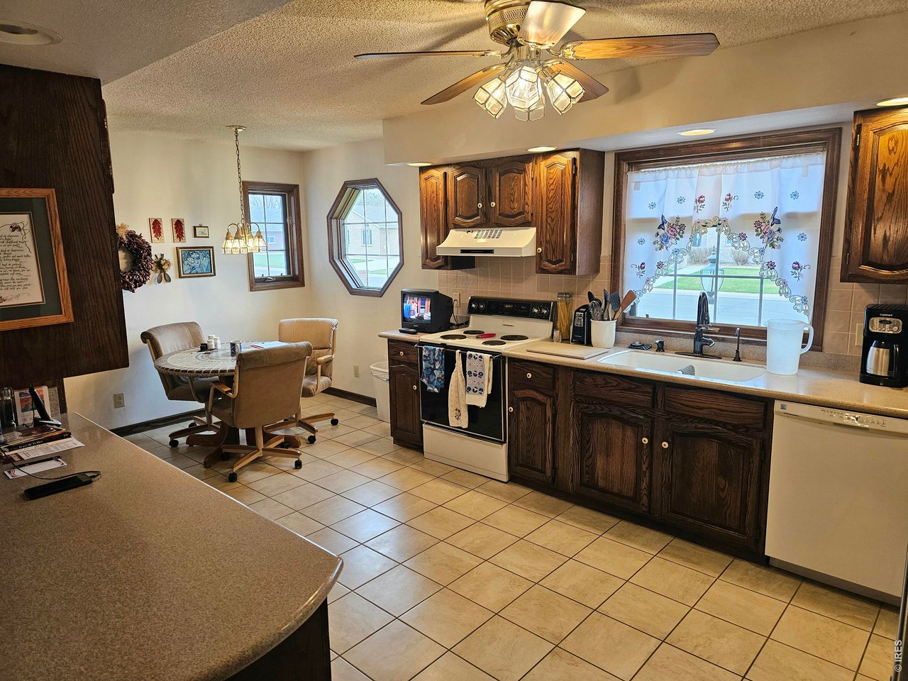 1010 Fairhurst Street Sterling, CO 80751 - Photo 10 of 36 a kitchen with cabinets and chairs