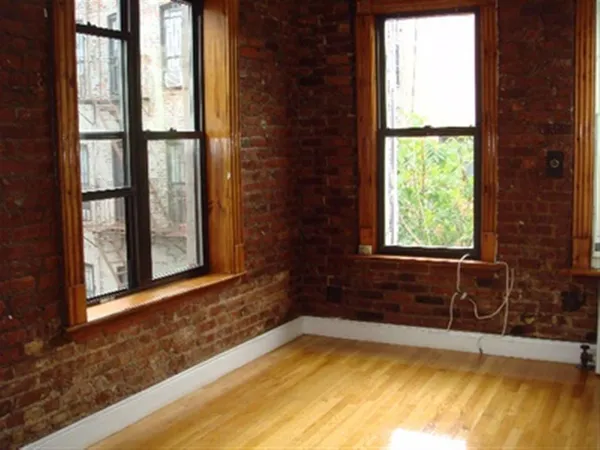 a view of a bathtub in a room with a window