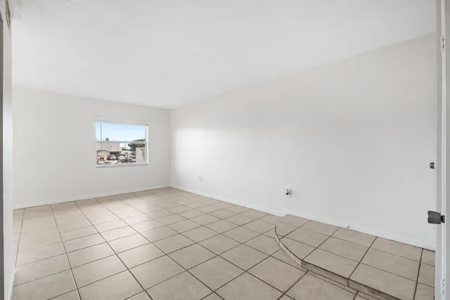 a view of an empty room and wooden floor