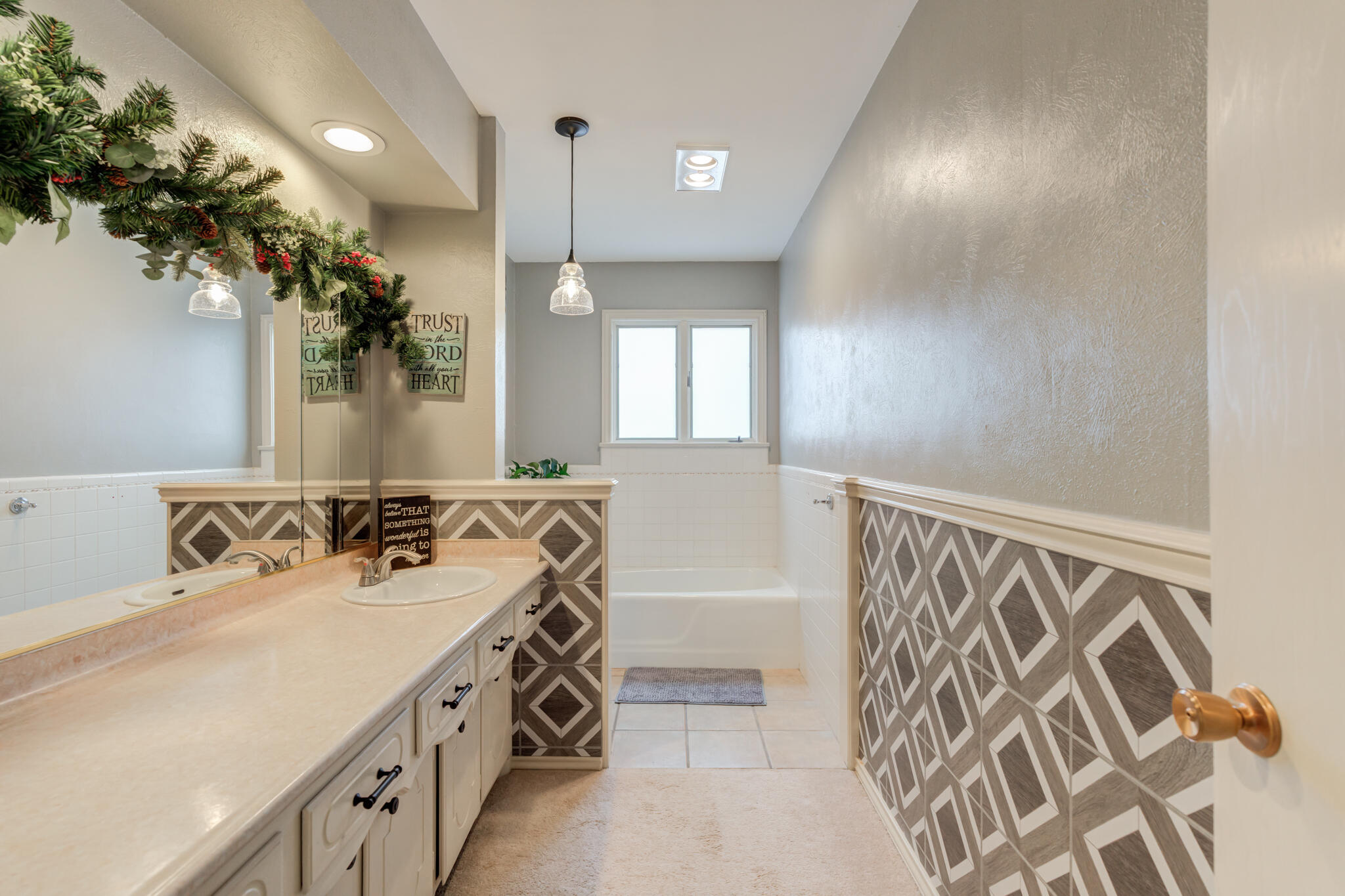 902 West 6th Street Idalou, TX 79329 - Photo 31 of 42 a spacious bathroom with a double vanity sink and a mirror