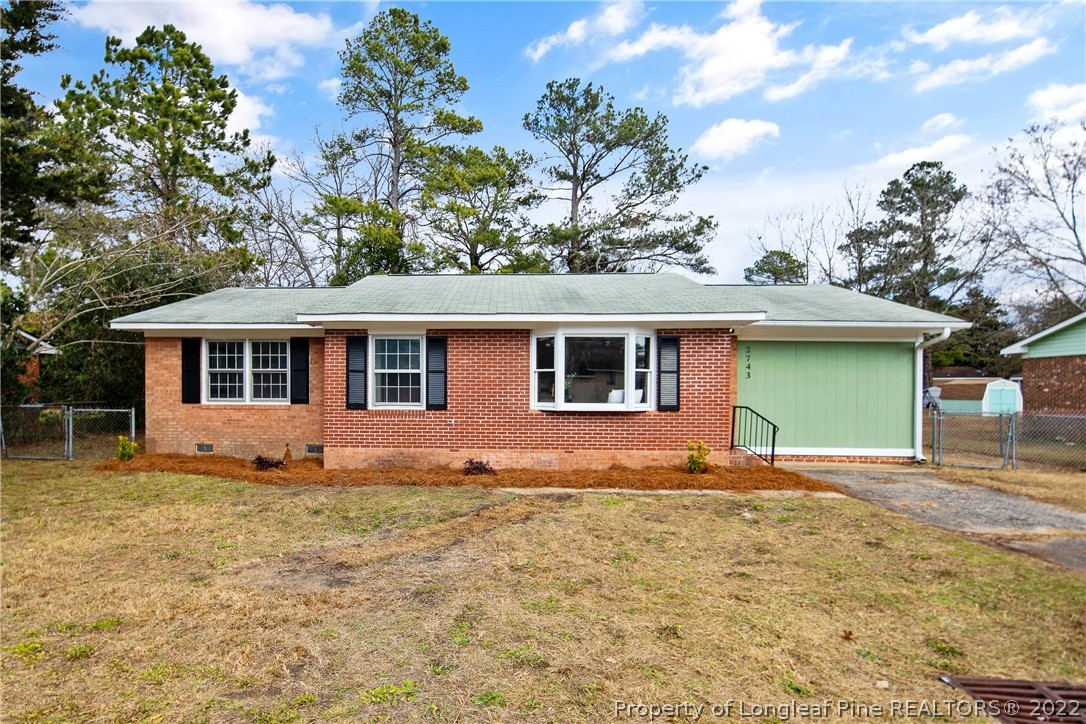 2743 George Owen Road Fayetteville, NC 28306 - Photo 1 of 47 a front view of a house with a garden and yard