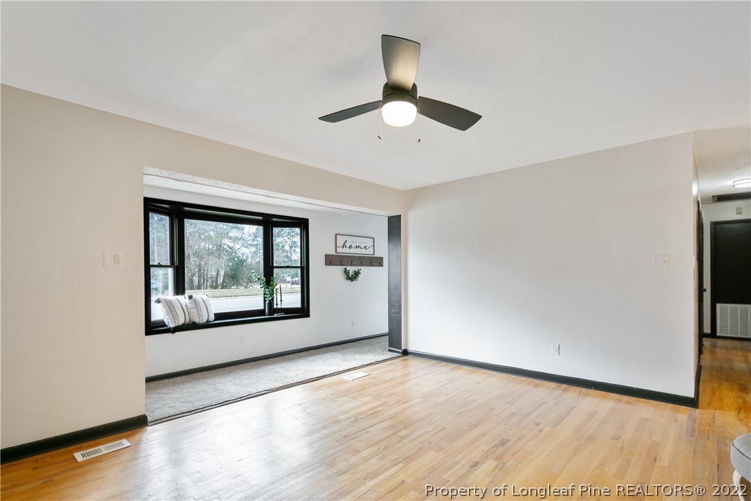 2743 George Owen Road Fayetteville, NC 28306 - Photo 12 of 47 a view of an empty room with a window and wooden floor