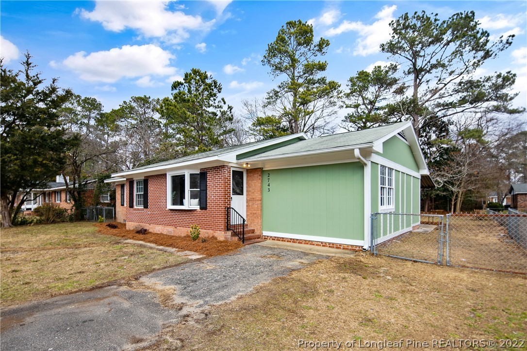 2743 George Owen Road Fayetteville, NC 28306 - Photo 2 of 47 a front view of a house with a yard and garage