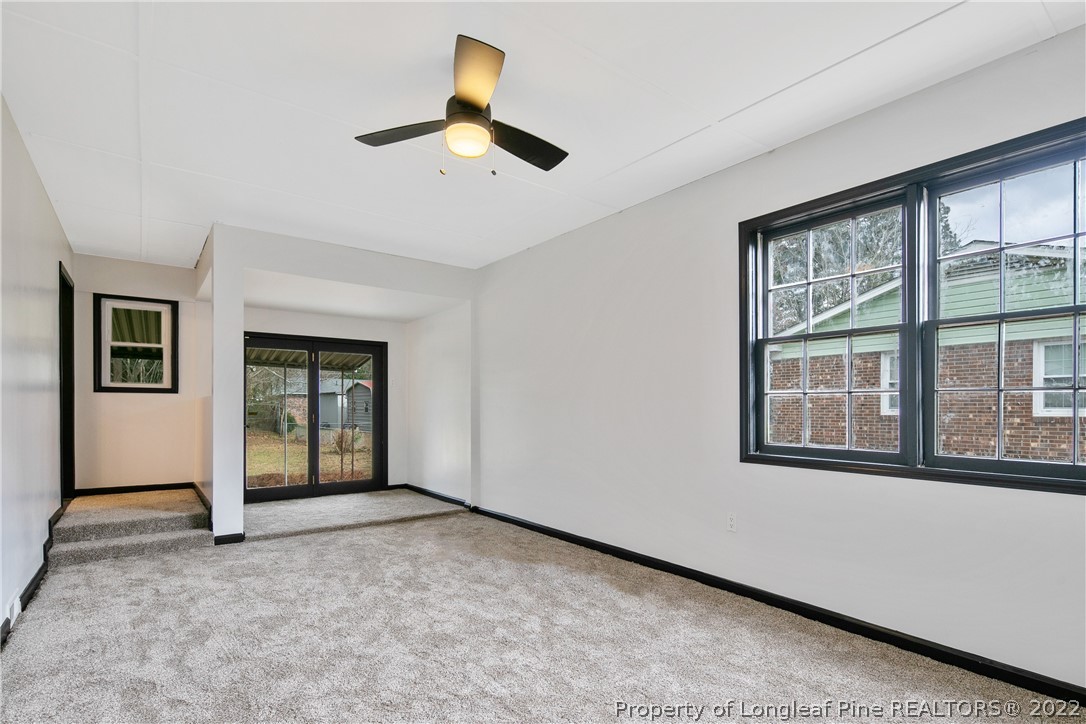 2743 George Owen Road Fayetteville, NC 28306 - Photo 26 of 47 an empty room with windows and ceiling fan