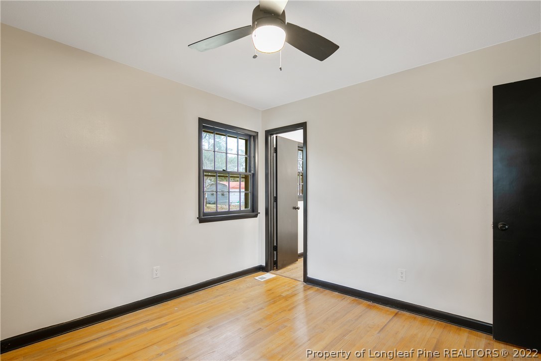 2743 George Owen Road Fayetteville, NC 28306 - Photo 29 of 47 a view of an empty room with window and wooden floor