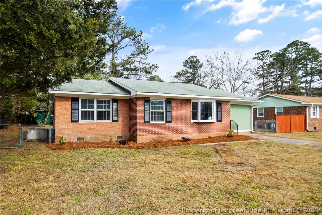 2743 George Owen Road Fayetteville, NC 28306 - Photo 3 of 47 a front view of a house with a yard