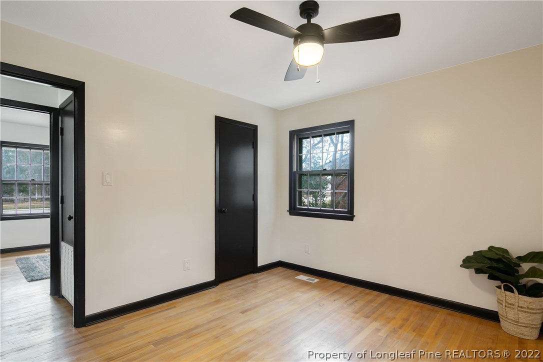 2743 George Owen Road Fayetteville, NC 28306 - Photo 31 of 47 an empty room with wooden floor closet and windows