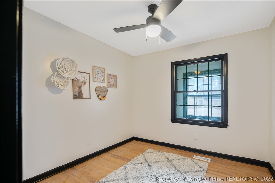 2743 George Owen Road Fayetteville, NC 28306 - Photo 34 of 47 an empty room with windows and fan