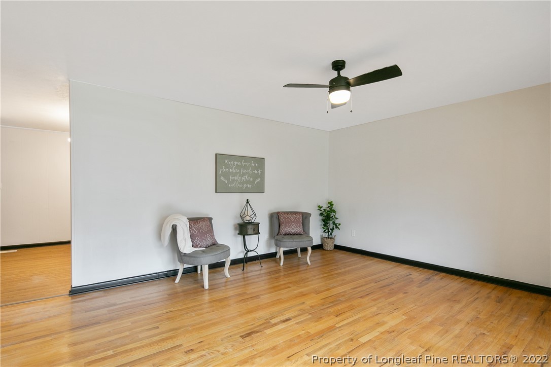 2743 George Owen Road Fayetteville, NC 28306 - Photo 8 of 47 a view of an empty room with wooden floor and a ceiling fan