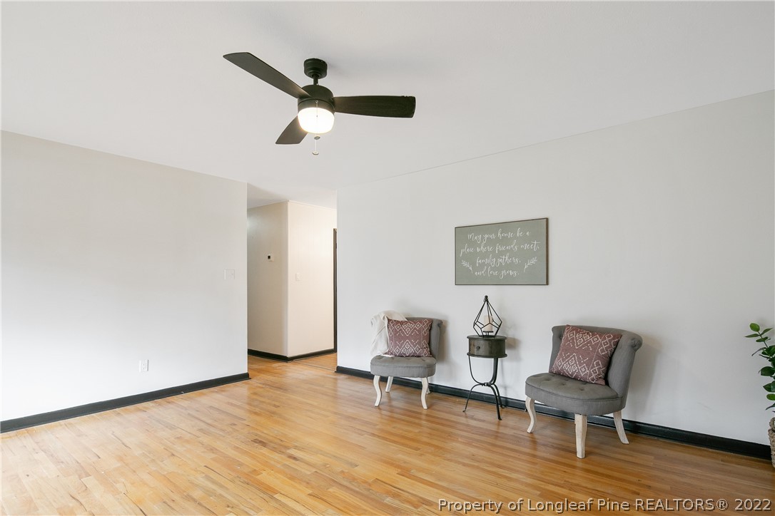2743 George Owen Road Fayetteville, NC 28306 - Photo 10 of 47 a view of a livingroom with a chair and wooden floor