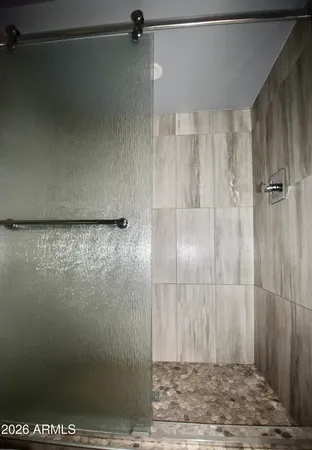 a bathroom with a granite countertop toilet sink and mirror