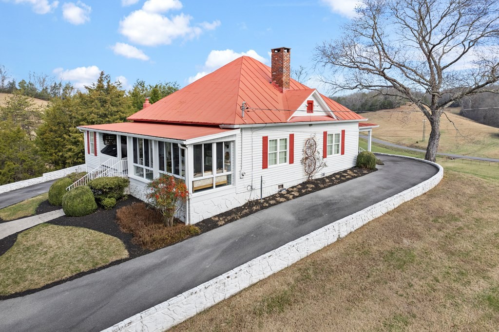 933 Millican Grove Road Sevierville, TN 37876 - Photo 41 of 54 a view of a house with a small yard and a large tree
