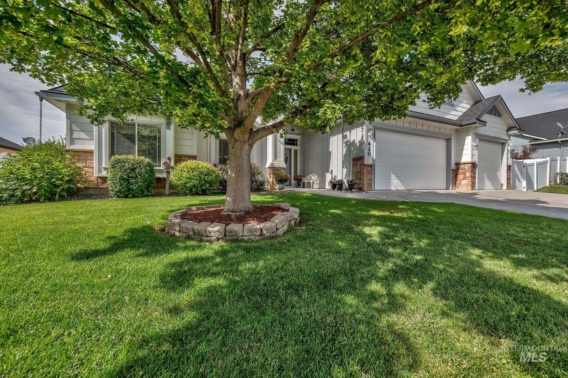420 West Indianhead Road Weiser, ID 83672 - Photo 2 of 40 Spacious front yard with mature tree, stone-edged planting bed, and manicured lawn