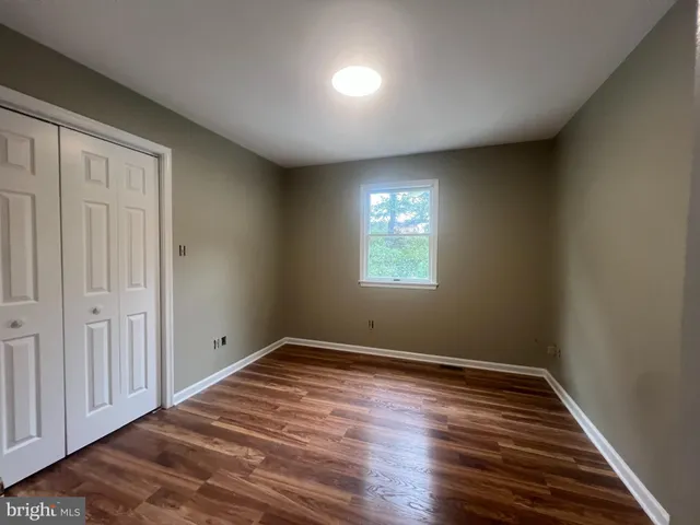 a view of room with window and wooden floor