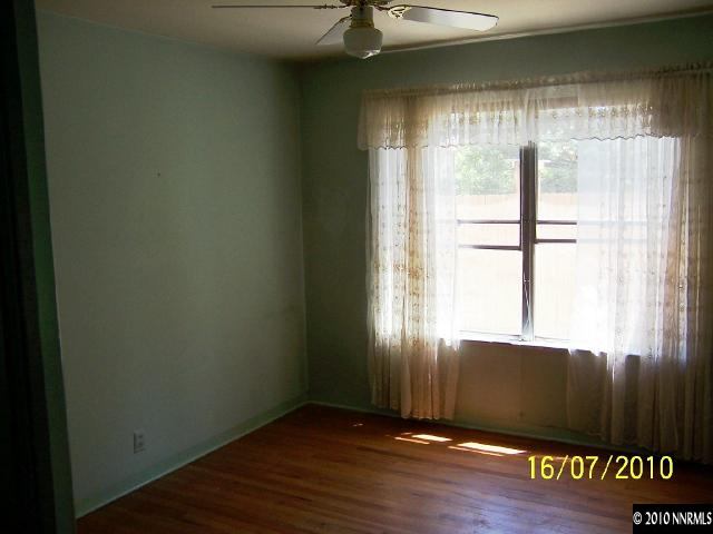 740-742 Monroe Street Reno, NV 89509 - Photo 3 of 5 an empty room with wooden floor and windows