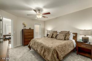 4850 East Desert Cove Avenue, Unit 227 Scottsdale, AZ 85254 - Photo 13 of 32 a bedroom with a bed and ceiling fan