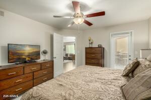 4850 East Desert Cove Avenue, Unit 227 Scottsdale, AZ 85254 - Photo 14 of 32 a bedroom with a bed and a flat screen tv