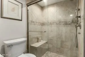 a white toilet sitting next to a bathroom sink