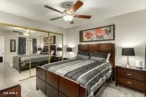 a bedroom with a bed and a flat screen tv