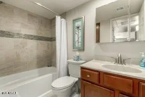 a bathroom with a sink toilet a mirror and shower