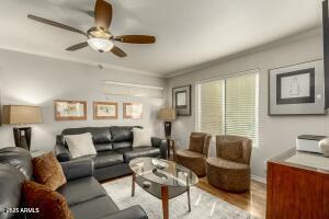 4850 East Desert Cove Avenue, Unit 227 Scottsdale, AZ 85254 - Photo 2 of 32 a living room with furniture and a large window