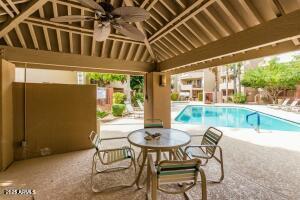 4850 East Desert Cove Avenue, Unit 227 Scottsdale, AZ 85254 - Photo 27 of 32 a patio with a table and chairs and potted plants
