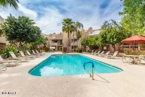 a swimming pool with outdoor seating and yard