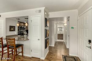 4850 East Desert Cove Avenue, Unit 227 Scottsdale, AZ 85254 - Photo 8 of 32 a view of a hallway with wooden floor and dining room view