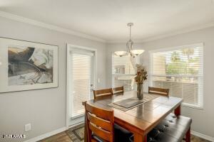 4850 East Desert Cove Avenue, Unit 227 Scottsdale, AZ 85254 - Photo 10 of 32 a view of a dining room with furniture window and wooden floor
