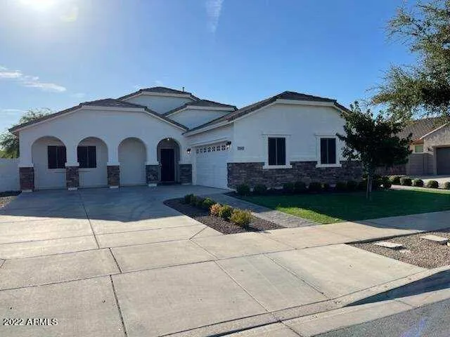 a view of a white house with a yard