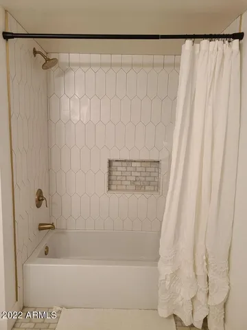 a bedroom with bed and a window