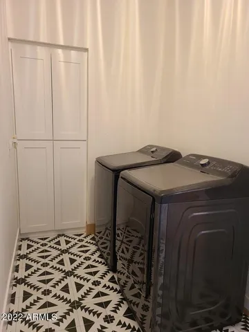 a bedroom with a bed window and a flat screen tv