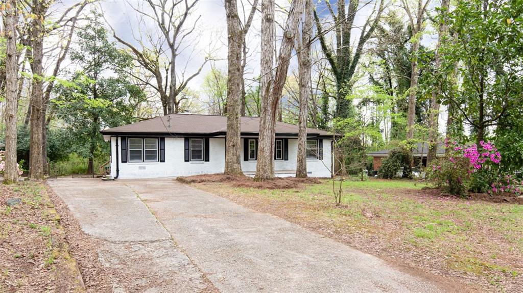 2850 Treadway Drive Decatur, GA 30034 - Photo 1 of 1 a front view of a house with a garden and trees
