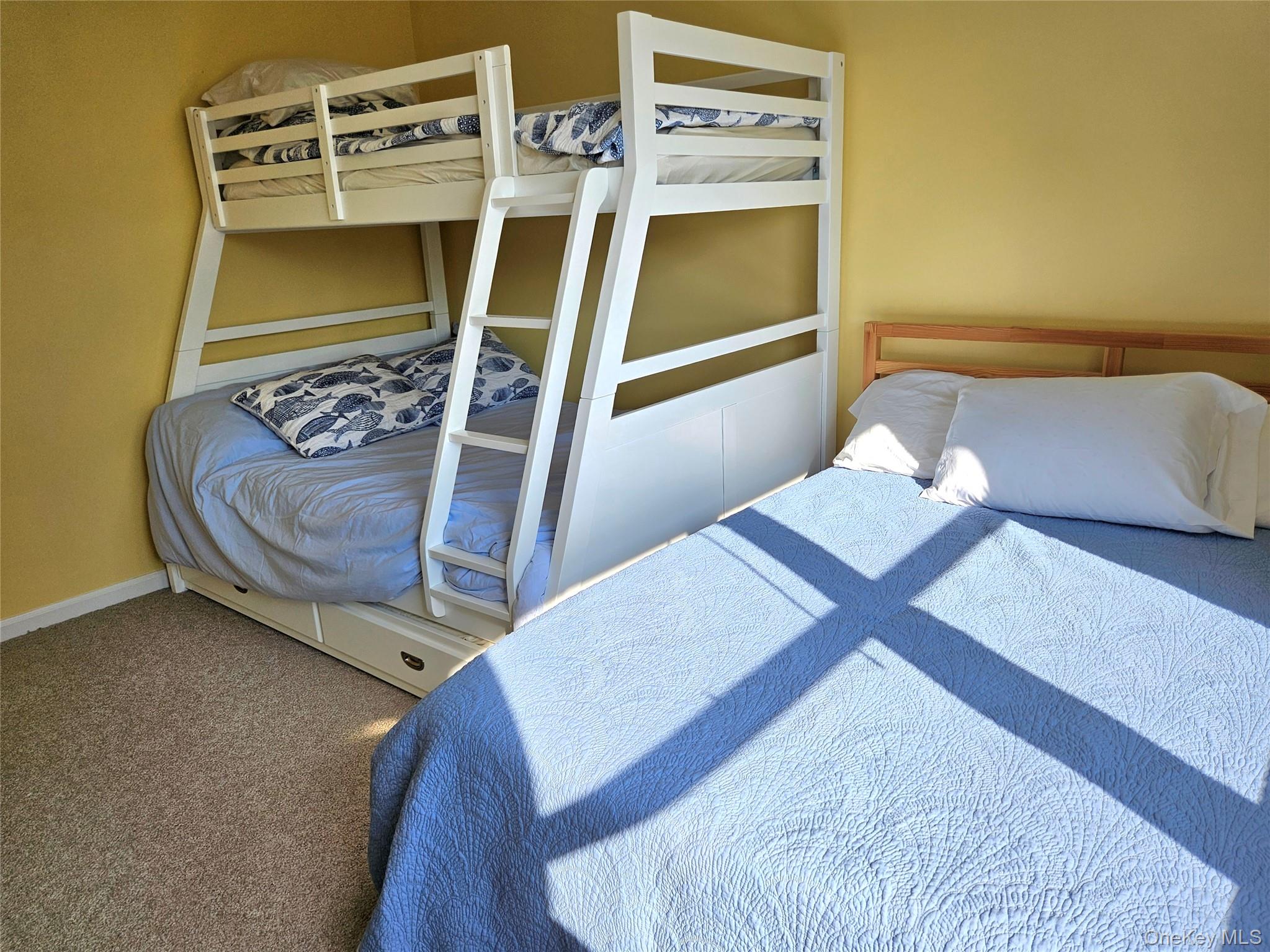 3650 Bay Shore Road Greenport, NY 11944 - Photo 27 of 30 a bed sitting in a room next to a window