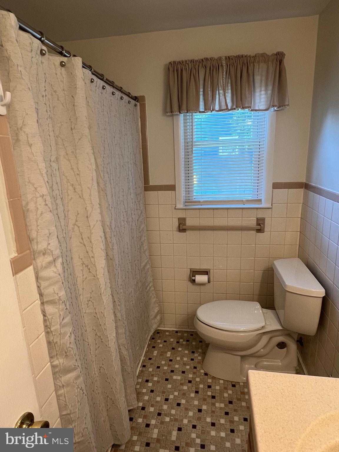 262 Evergreen Avenue, Unit 1 Hamilton, NJ 08619 - Photo 13 of 20 a bathroom with a toilet and a shower curtain