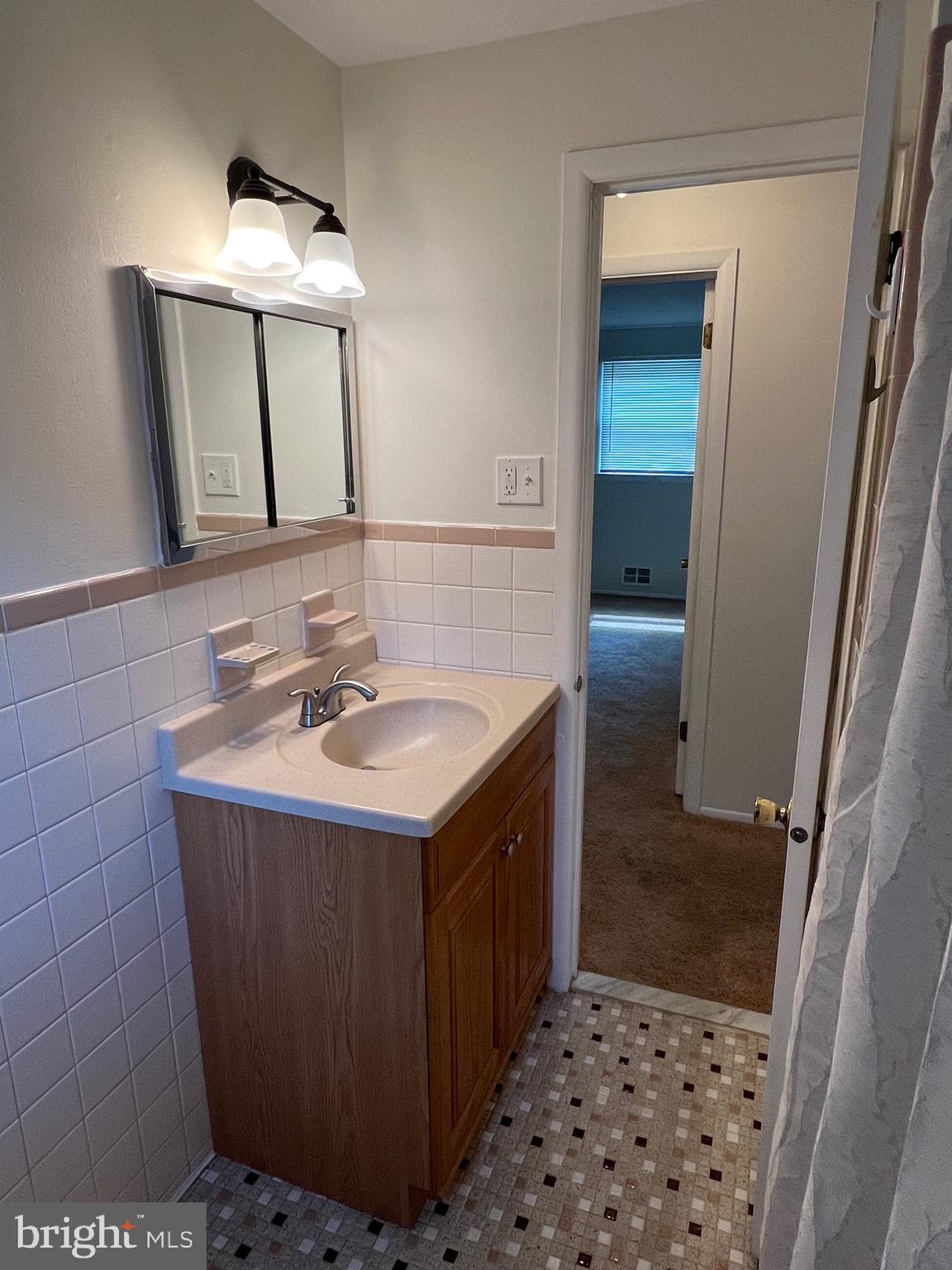 262 Evergreen Avenue, Unit 1 Hamilton, NJ 08619 - Photo 15 of 20 a bathroom with a sink a mirror and a shower