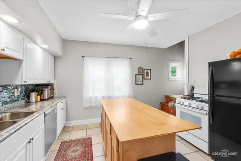 a kitchen with a stove a sink and a refrigerator