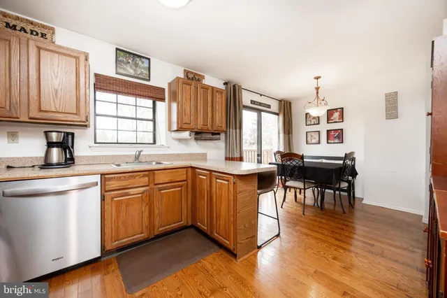 a kitchen with stainless steel appliances granite countertop sink stove top oven and cabinets