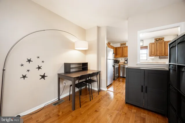 a view of a workspace with furniture and wooden floor