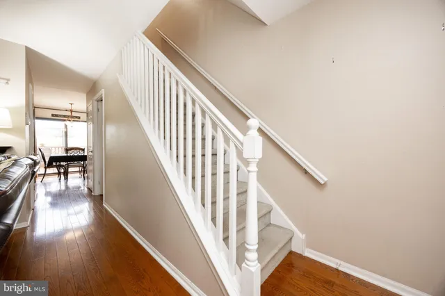 a view of entryway and hall with wooden floor