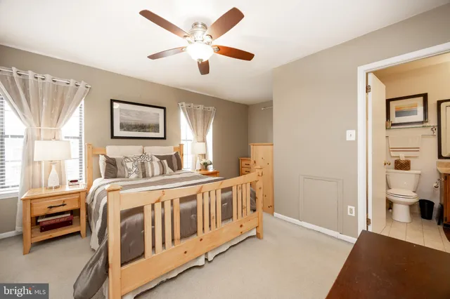 a view of a bedroom with furniture and windows