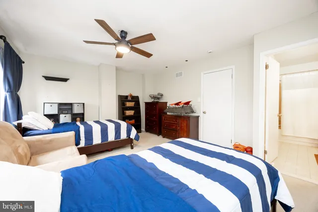 a bedroom with a bed couch and a window