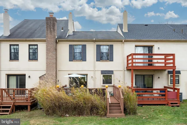 a front view of a house with a yard table and chairs