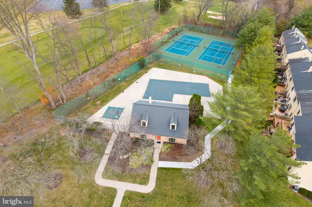 an aerial view of a house with swimming pool a yard and a fountain