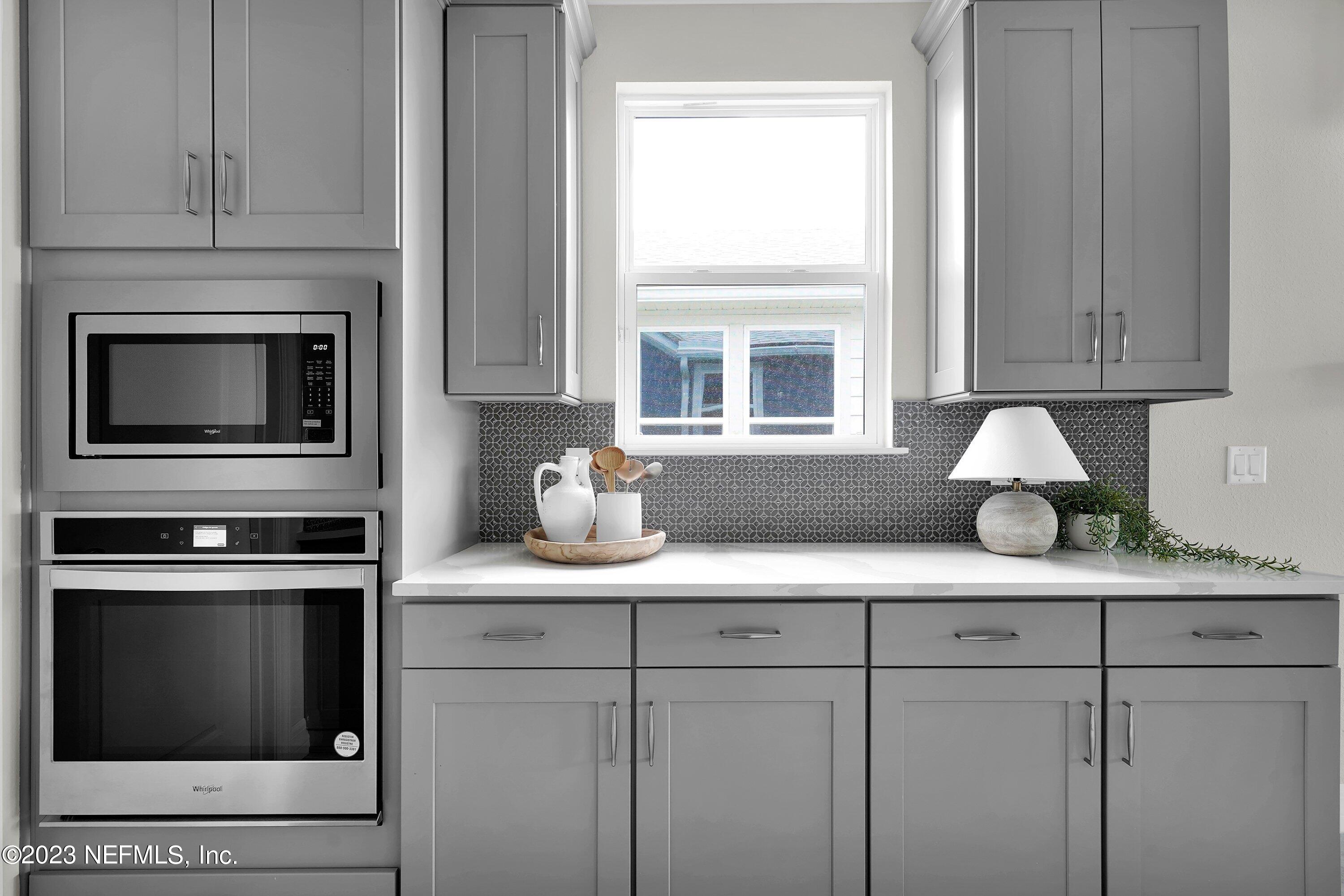 384 Del Webb Parkway Yulee, FL 32097 - Photo 11 of 35 a kitchen with appliances cabinets and a window