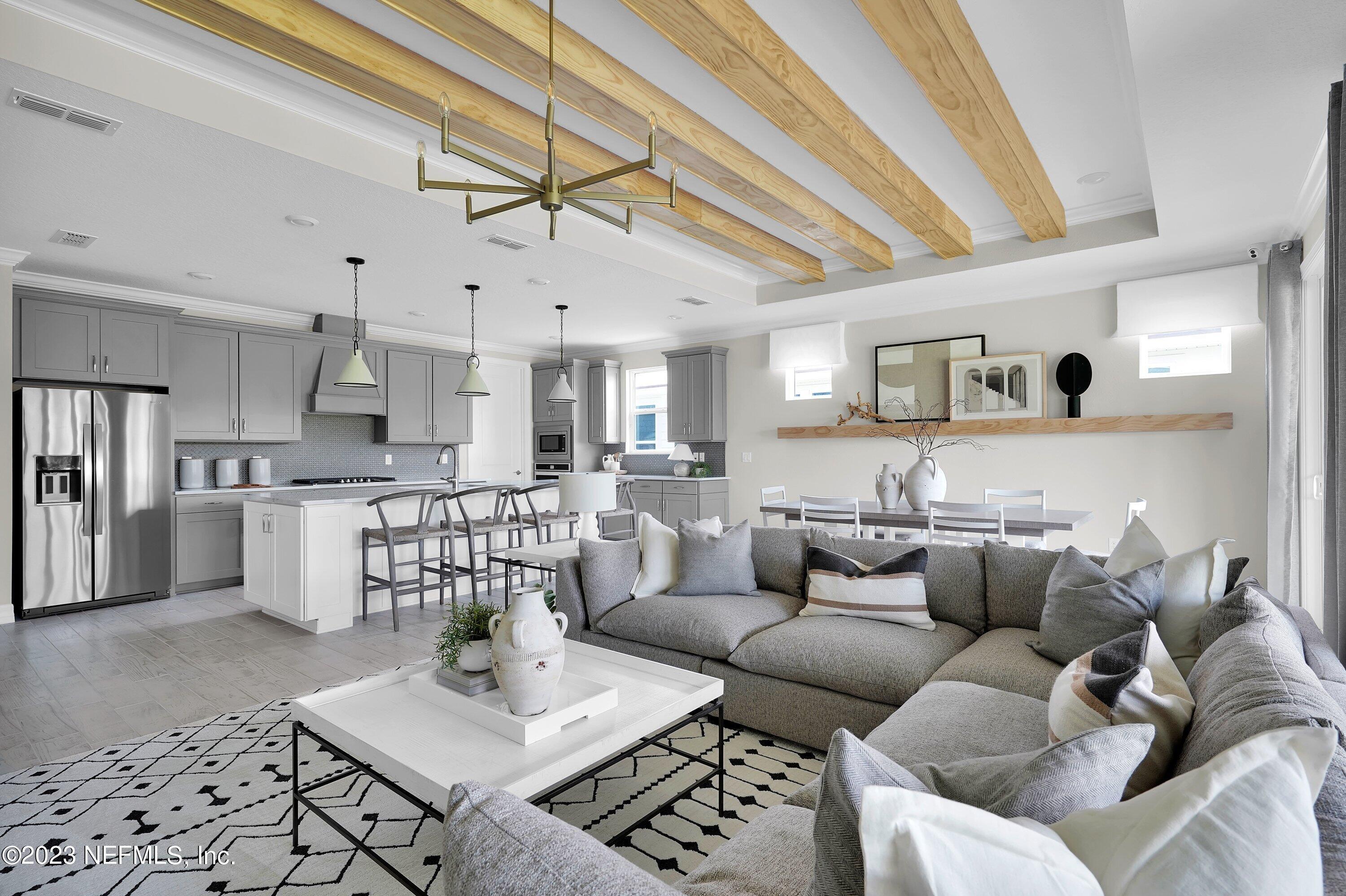 384 Del Webb Parkway Yulee, FL 32097 - Photo 13 of 35 a living room with furniture kitchen view and a chandelier