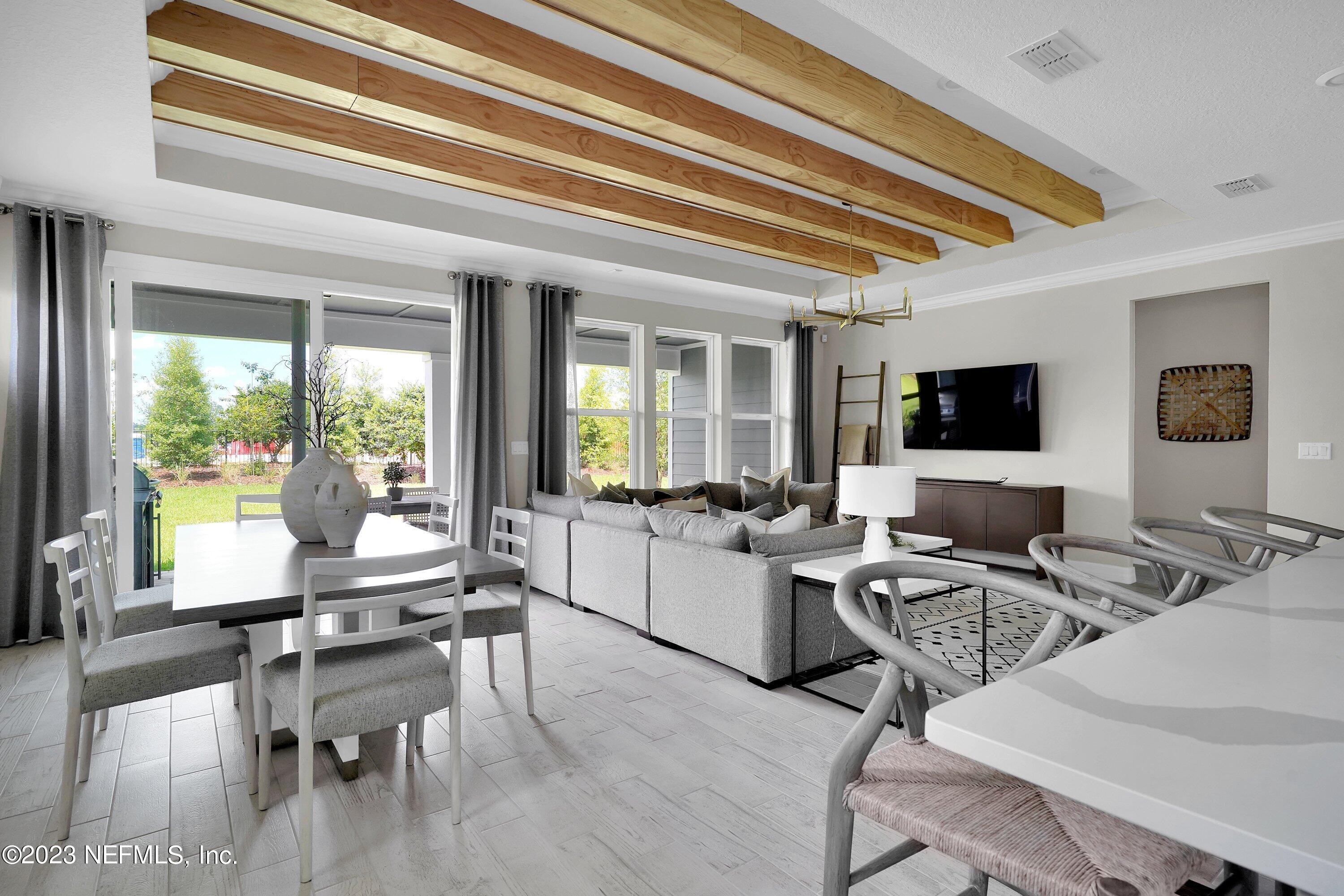 384 Del Webb Parkway Yulee, FL 32097 - Photo 14 of 35 a room with furniture and a flat screen tv