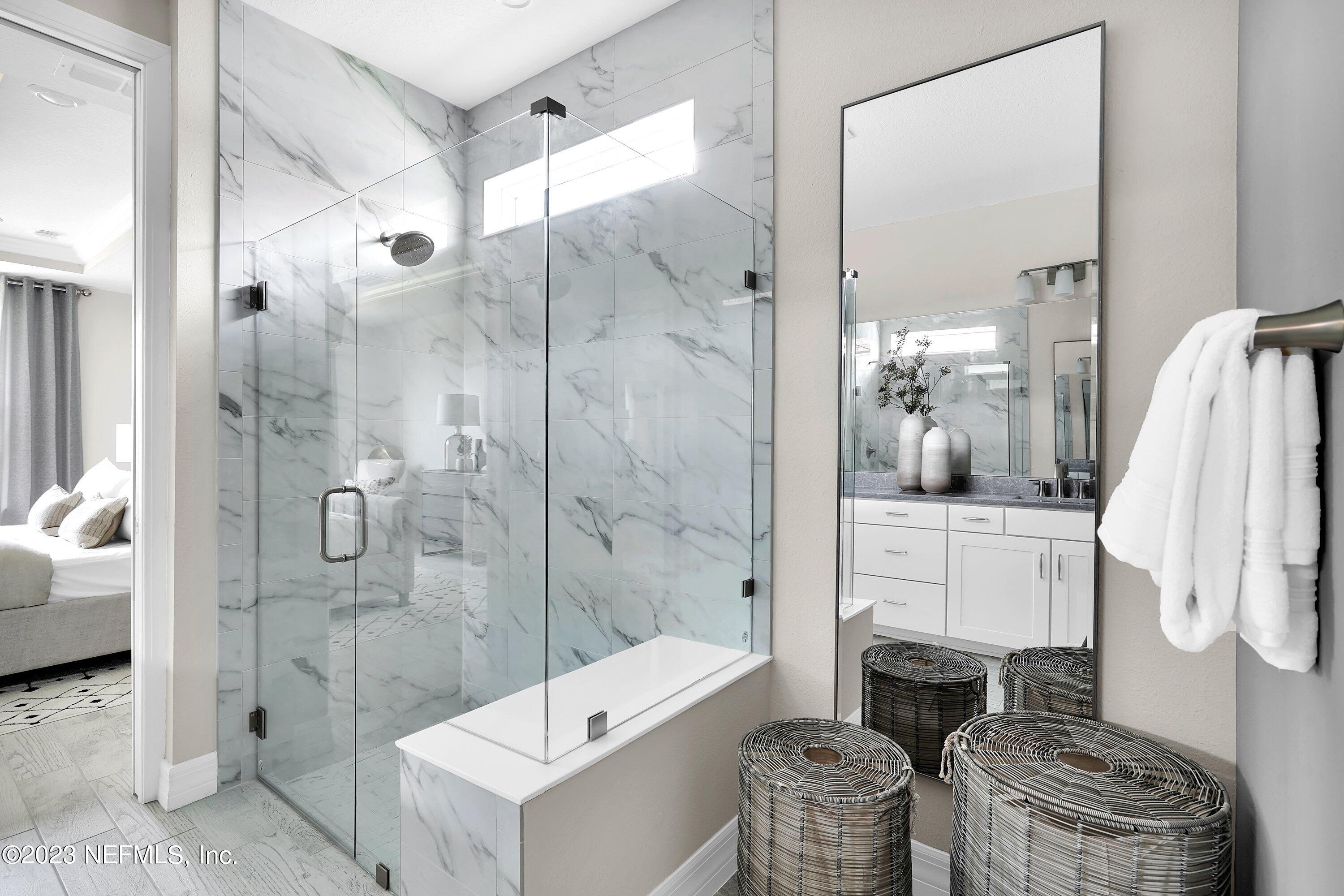 384 Del Webb Parkway Yulee, FL 32097 - Photo 21 of 35 a bathroom with a tub shower and sink