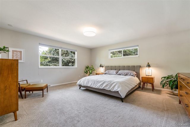 a spacious bedroom with a bed and a window